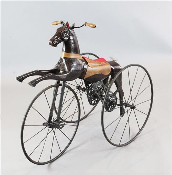 A 19th century French wrought and cast iron velocipede modelled as a racing horse, Overall length 42in. height 3ft 2in.